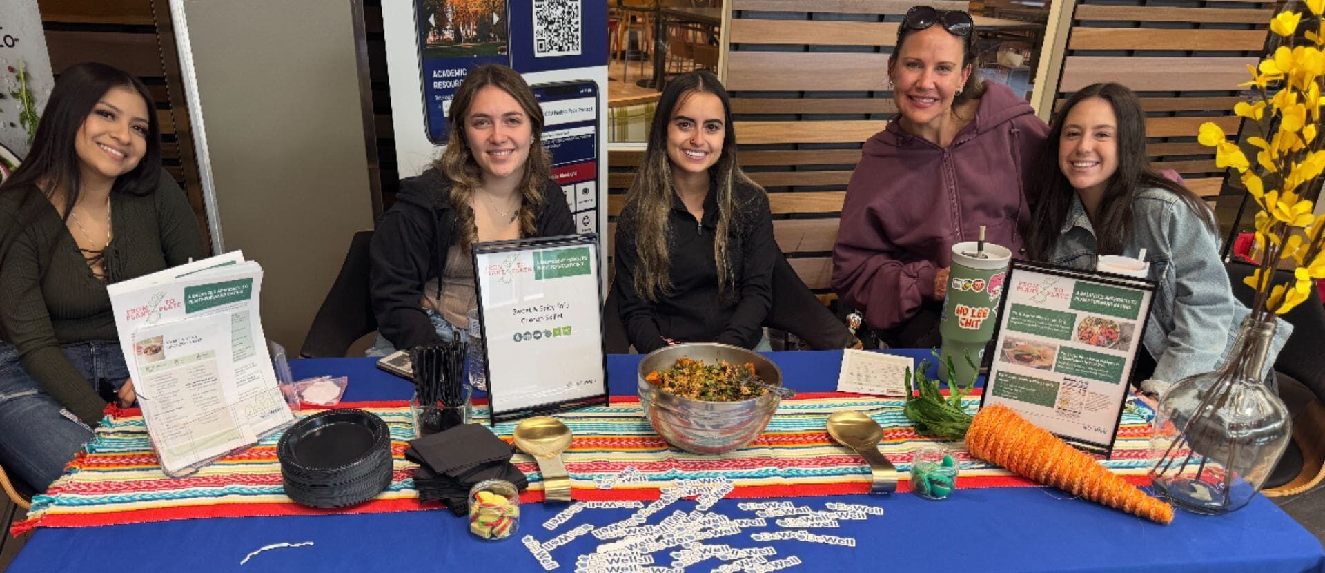 picture of students at BeWell table